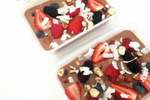 overnight oats with berries and coconut in plastic box