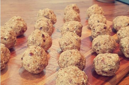 23 protein balls on wooden cutting board